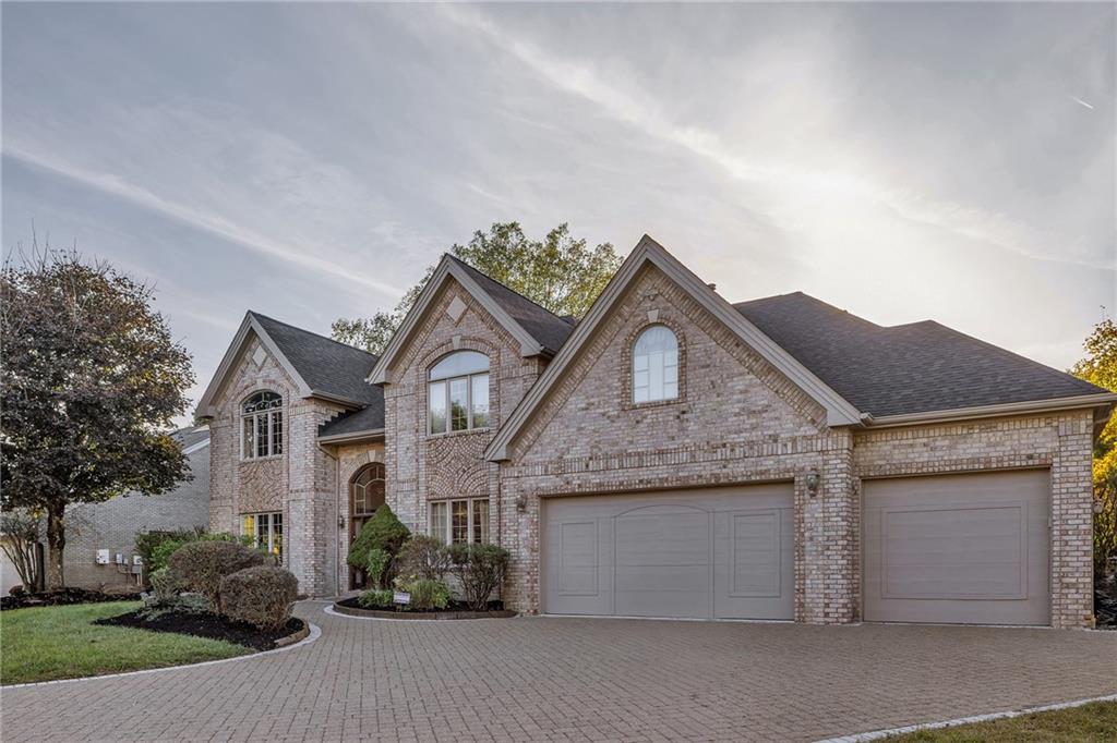 5010 Prides Court Murrysville, PA 15668 - Photo 3 of 49 a front view of a house with a garden and garage