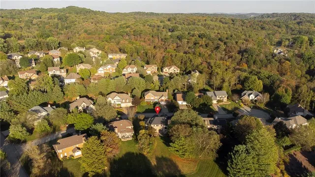 an aerial view of a house with a yard and garden