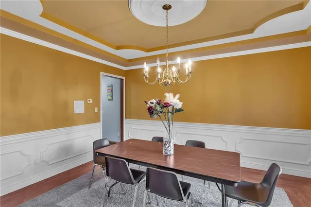 a view of a dining room with furniture and chandelier