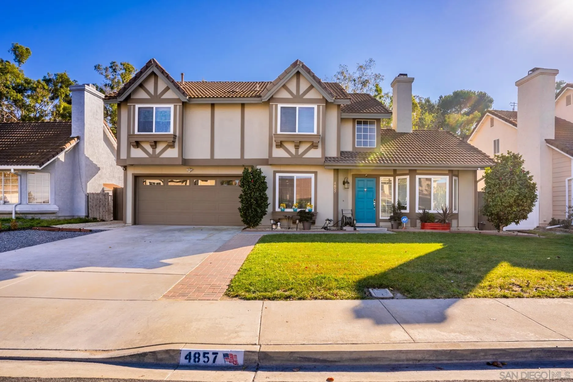 a view of a house with swimming pool and a yard
