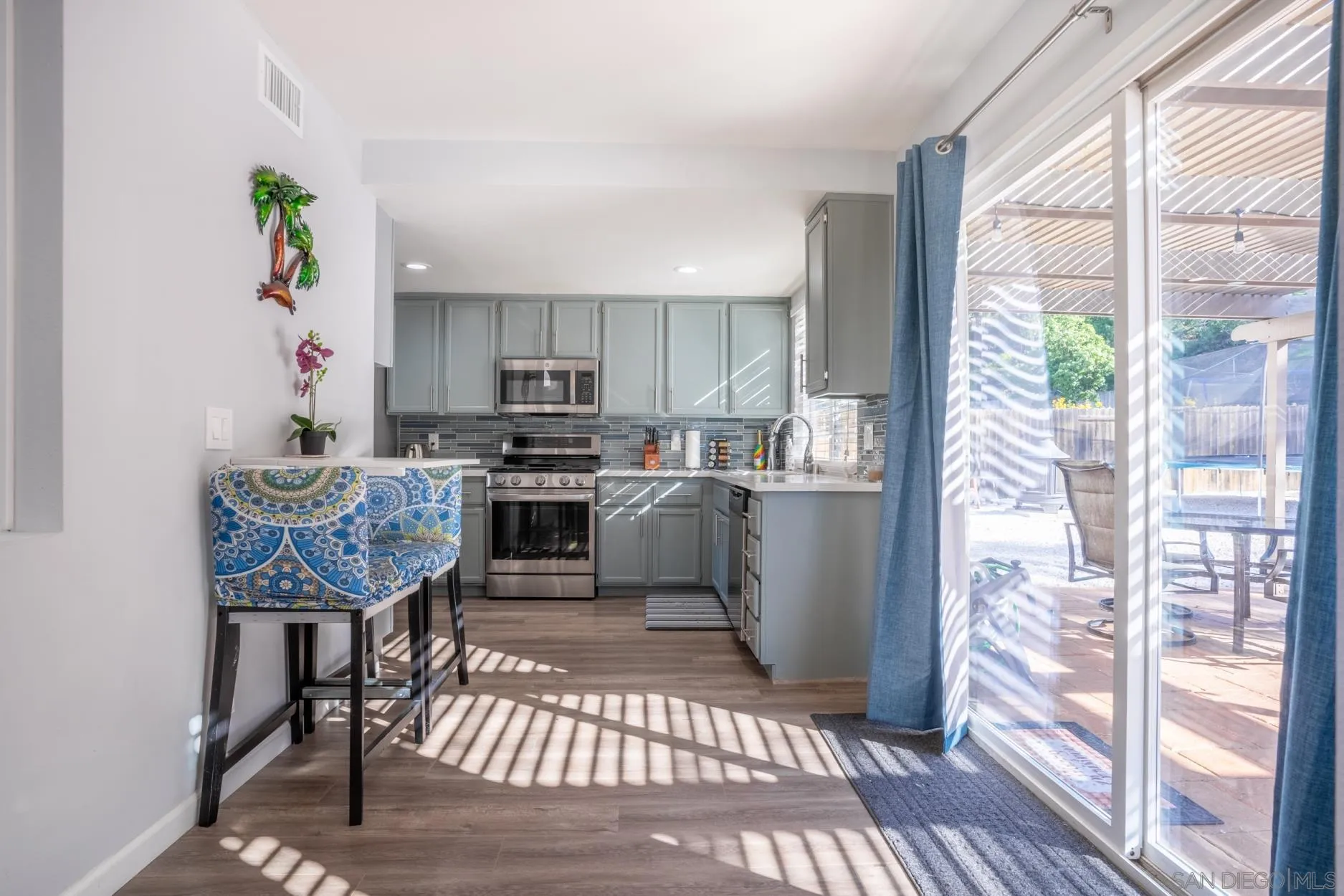 4857 Northerly Street Oceanside, CA 92056 - Photo 15 of 32 a kitchen with stainless steel appliances granite countertop a refrigerator and a stove top oven