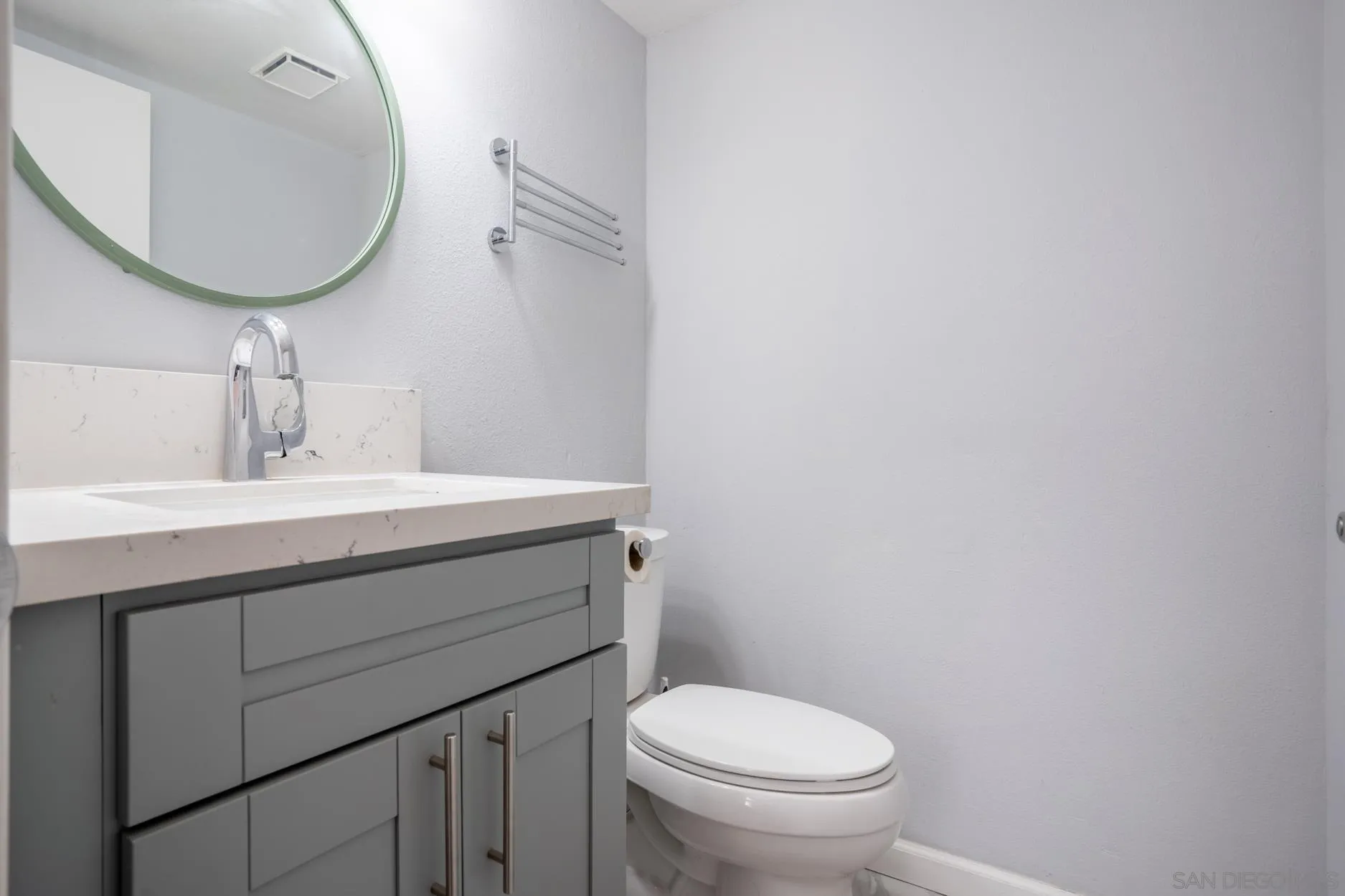 4857 Northerly Street Oceanside, CA 92056 - Photo 17 of 32 a bathroom with a toilet sink and mirror