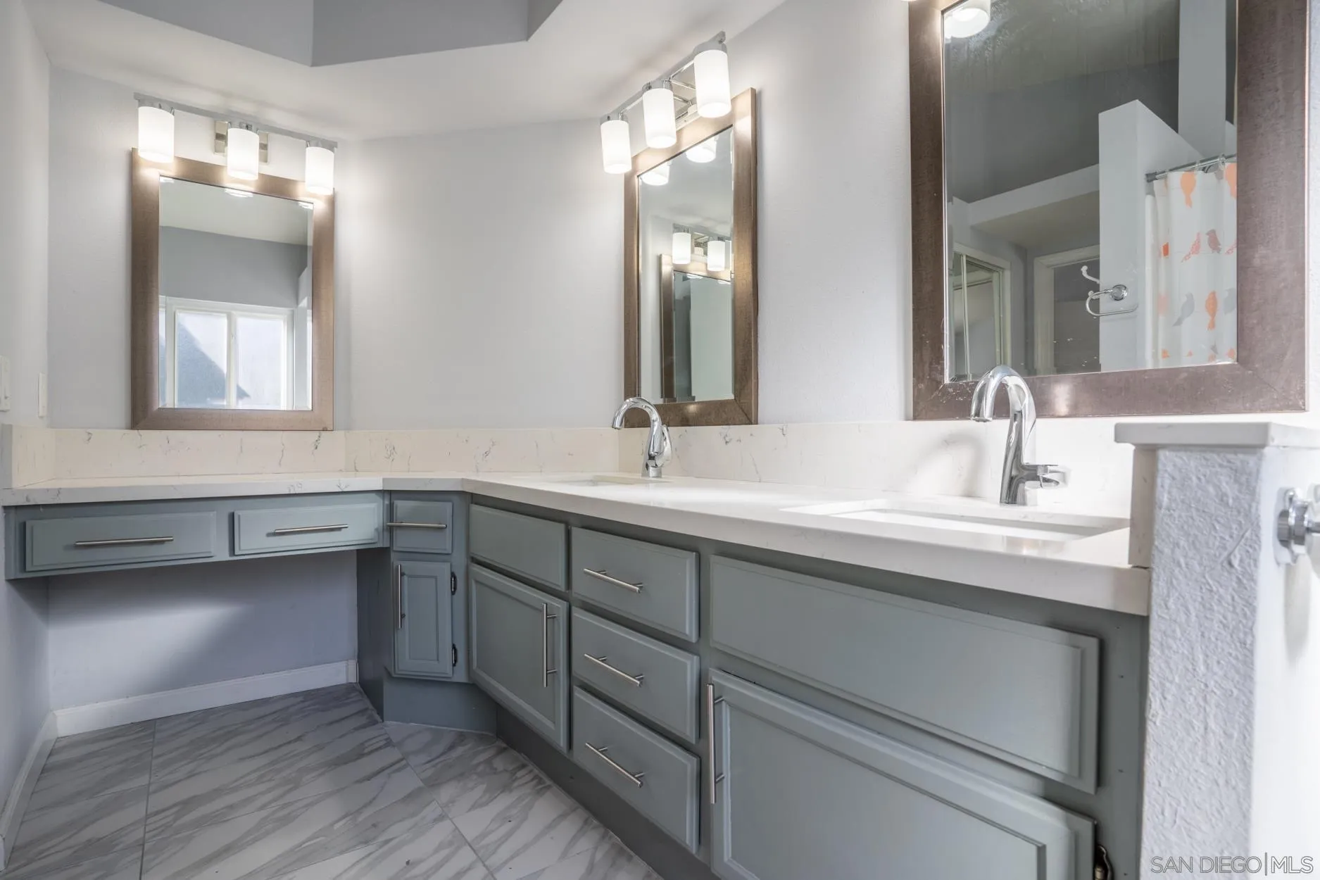 4857 Northerly Street Oceanside, CA 92056 - Photo 24 of 32 a bathroom with a double vanity sink and a mirror