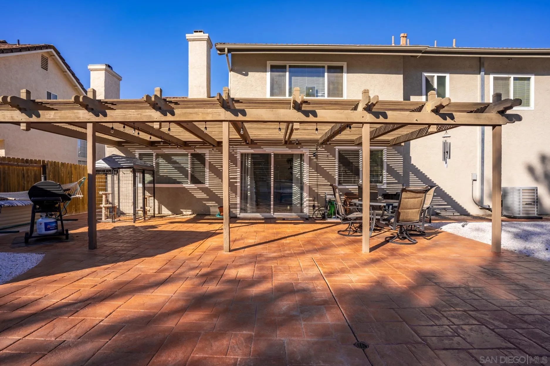 4857 Northerly Street Oceanside, CA 92056 - Photo 31 of 32 a view of a patio with table and chairs a barbeque