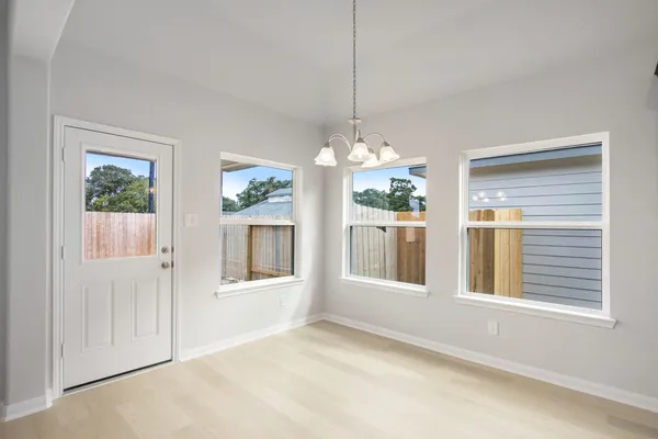 a large kitchen with stainless steel appliances sink a stove and cabinets