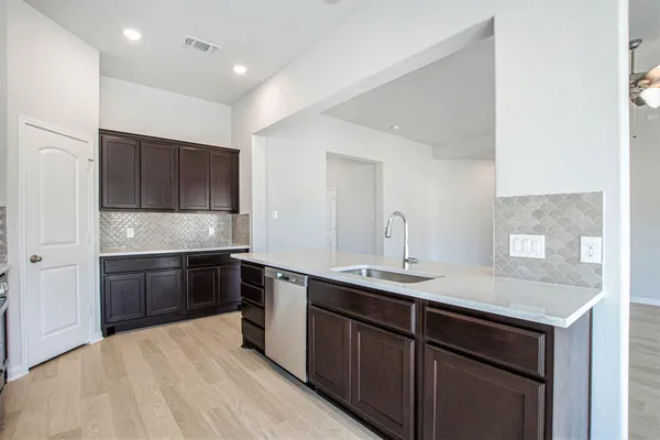 a spacious bathroom with a granite countertop sink a mirror and a shower