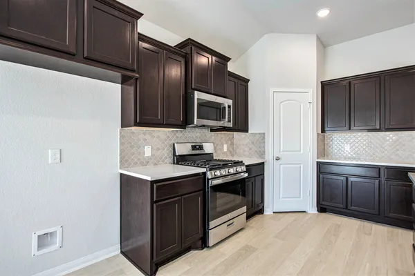 a spacious bathroom with a granite countertop sink a mirror and a shower