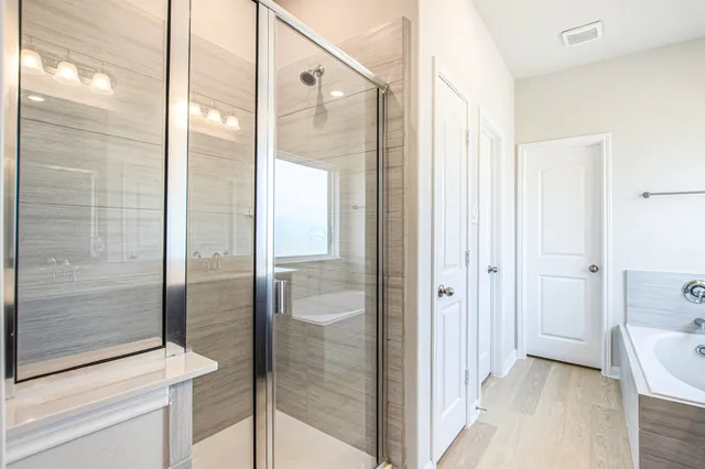 a bathroom with a glass shower door