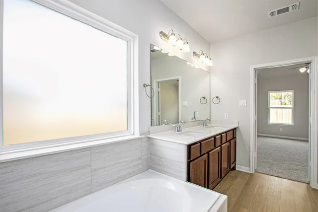a bathroom with a sink a light fixture and a mirror