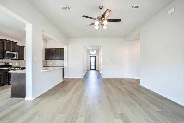 a kitchen with stainless steel appliances a stove top oven a sink a refrigerator a window