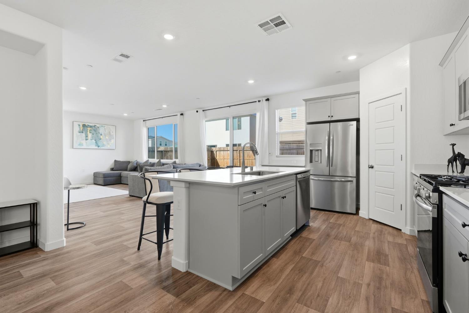 4225 Hampton Way Clovis, CA 93619 - Photo 21 of 64 a kitchen with refrigerator cabinets and wooden floor