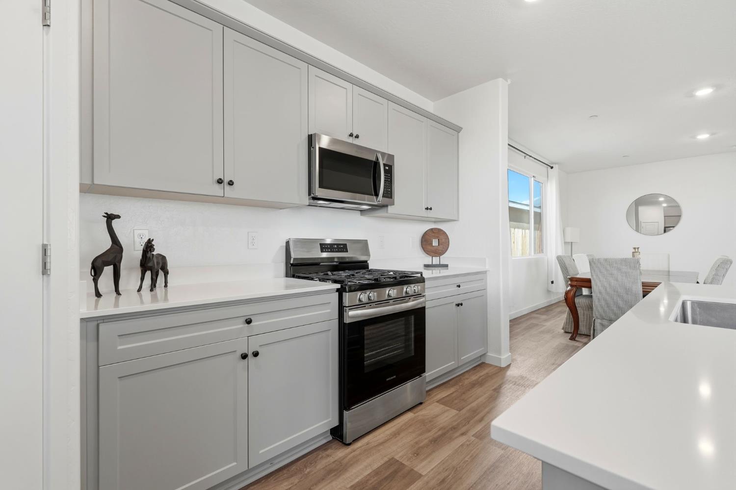 4225 Hampton Way Clovis, CA 93619 - Photo 24 of 64 a kitchen with cabinets stainless steel appliances and sink