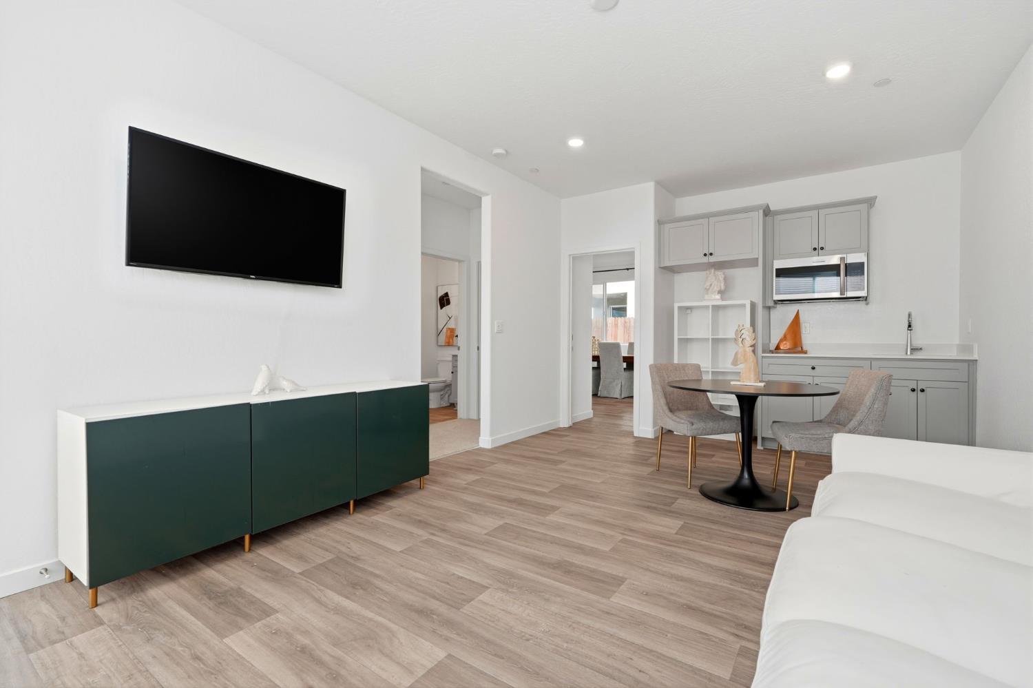 4225 Hampton Way Clovis, CA 93619 - Photo 31 of 64 a living room with stainless steel appliances kitchen island furniture and a flat screen tv