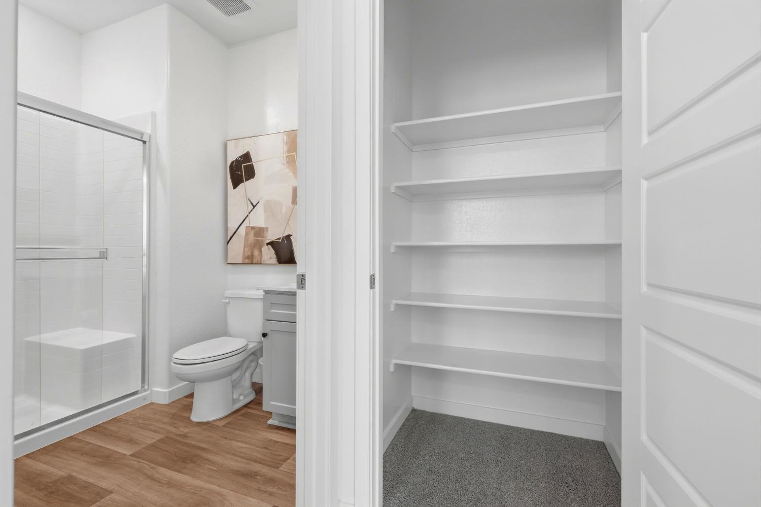 4225 Hampton Way Clovis, CA 93619 - Photo 36 of 64 a bathroom with a toilet and a shower curtain