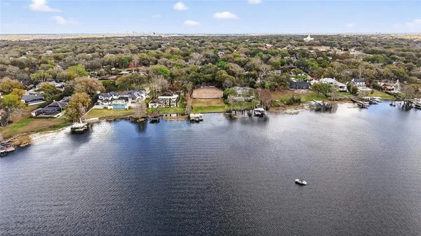 an aerial view of a houses with a yard