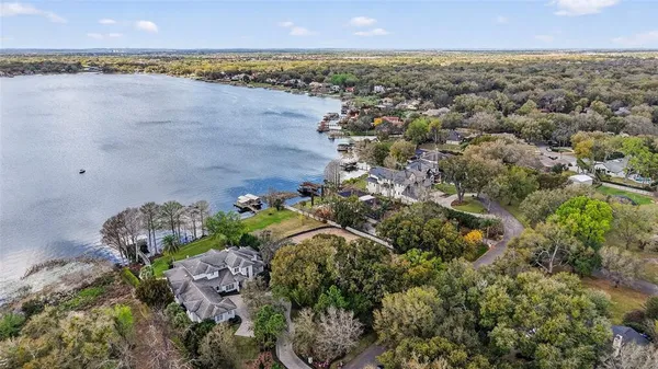 a aerial view of a house with swimming pool and a yard