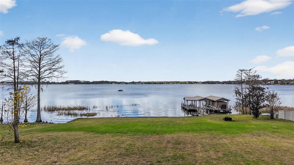 2624 Midsummer Drive Windermere, FL 34786 - Photo 20 of 22 a view of a lake with a big yard and a large building