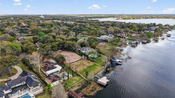 an aerial view of residential houses with outdoor space and swimming pool