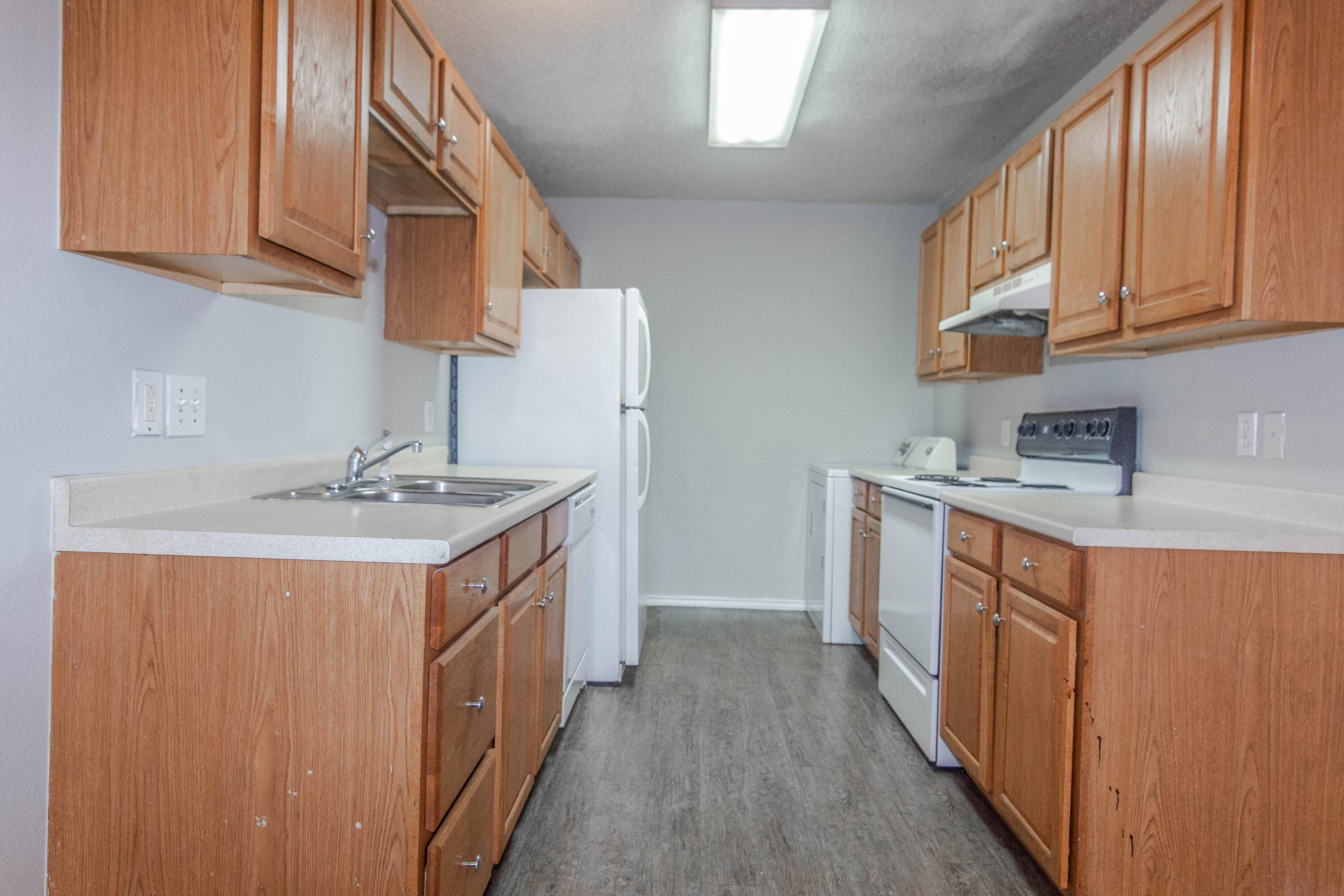 2409 87th Street, Unit B Lubbock, TX 79423 - Photo 2 of 11 a kitchen with stainless steel appliances granite countertop a sink stove and cabinets