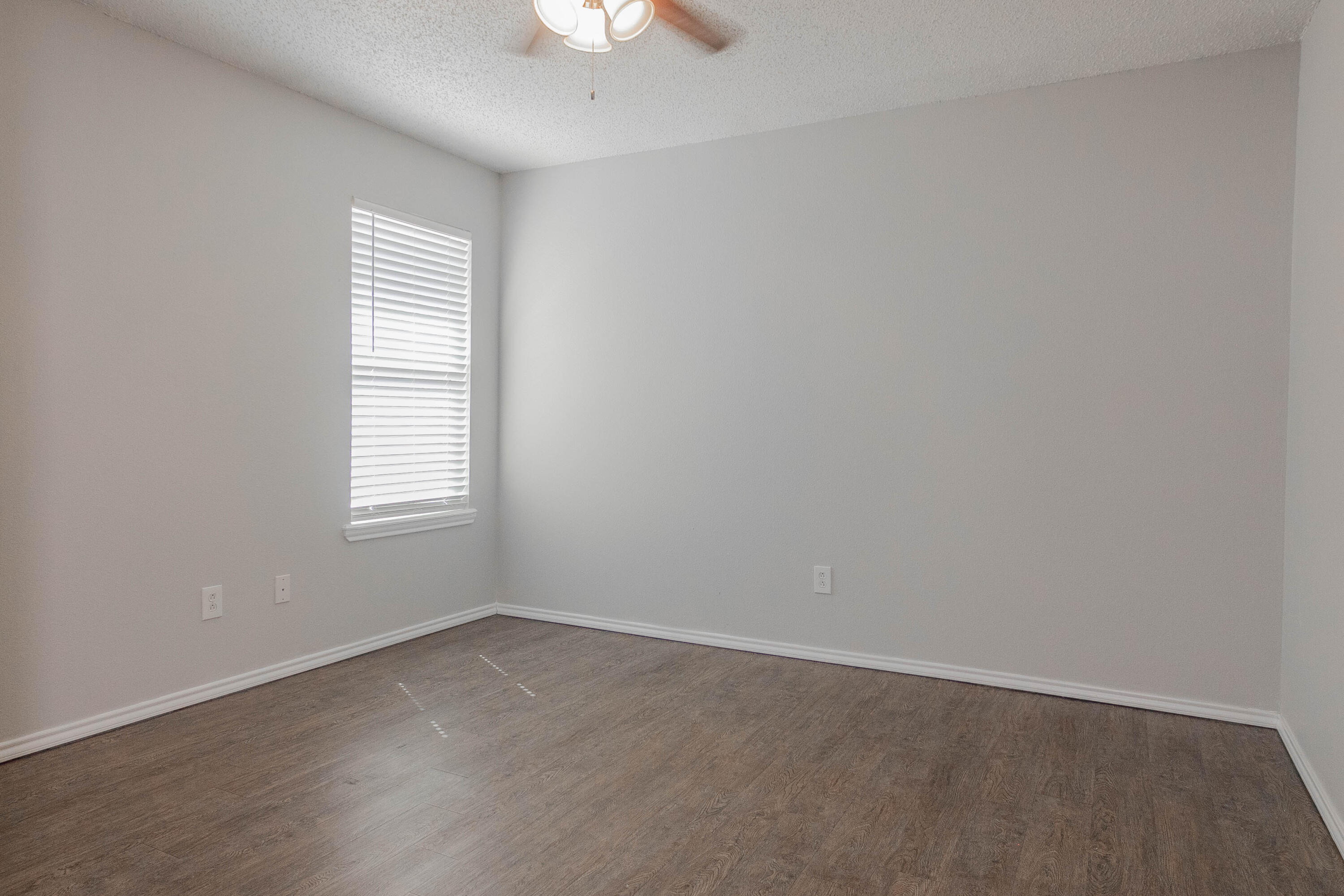 2409 87th Street, Unit B Lubbock, TX 79423 - Photo 4 of 11 an empty room with a window