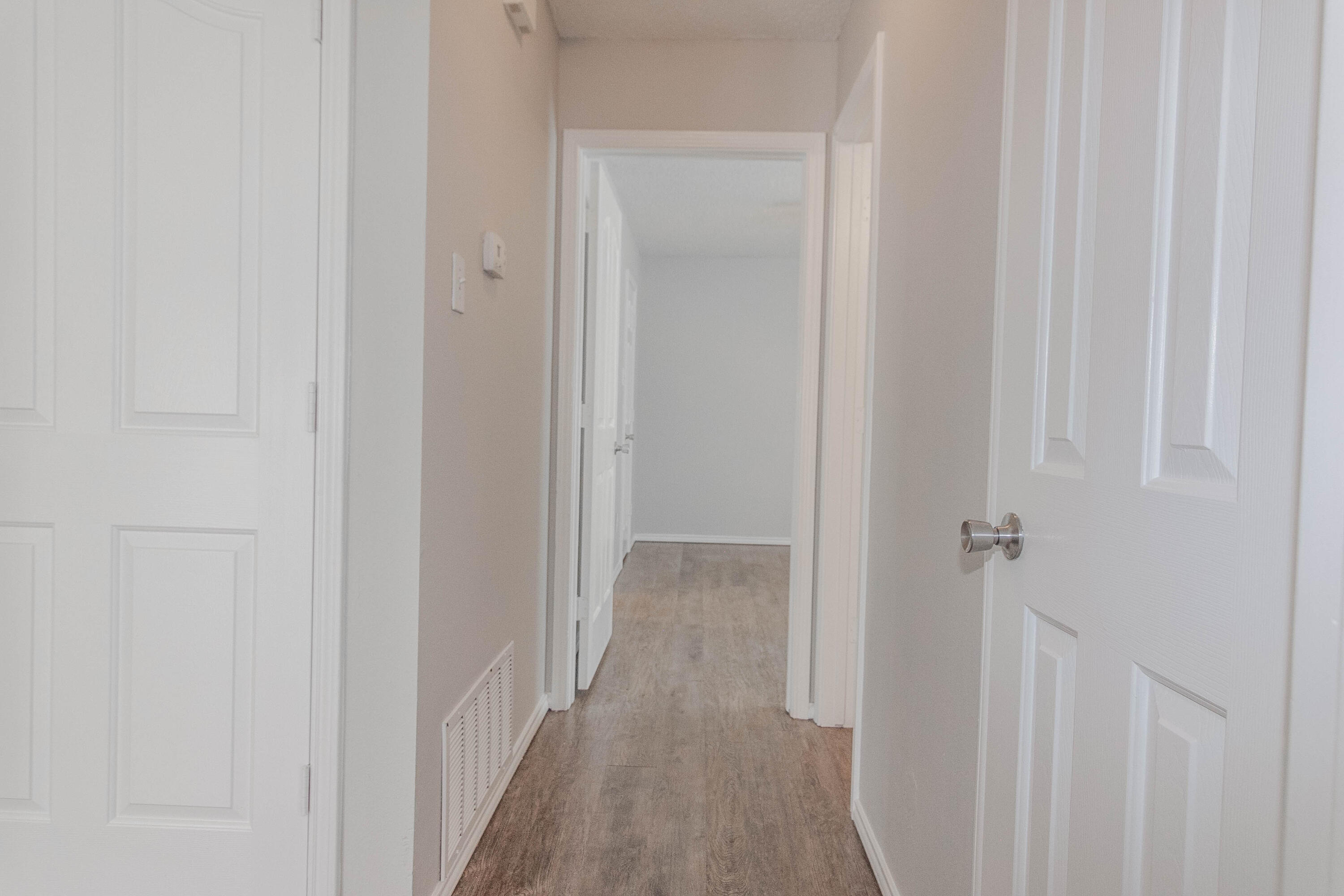 2409 87th Street, Unit B Lubbock, TX 79423 - Photo 5 of 11 a view of a hallway with wooden floor