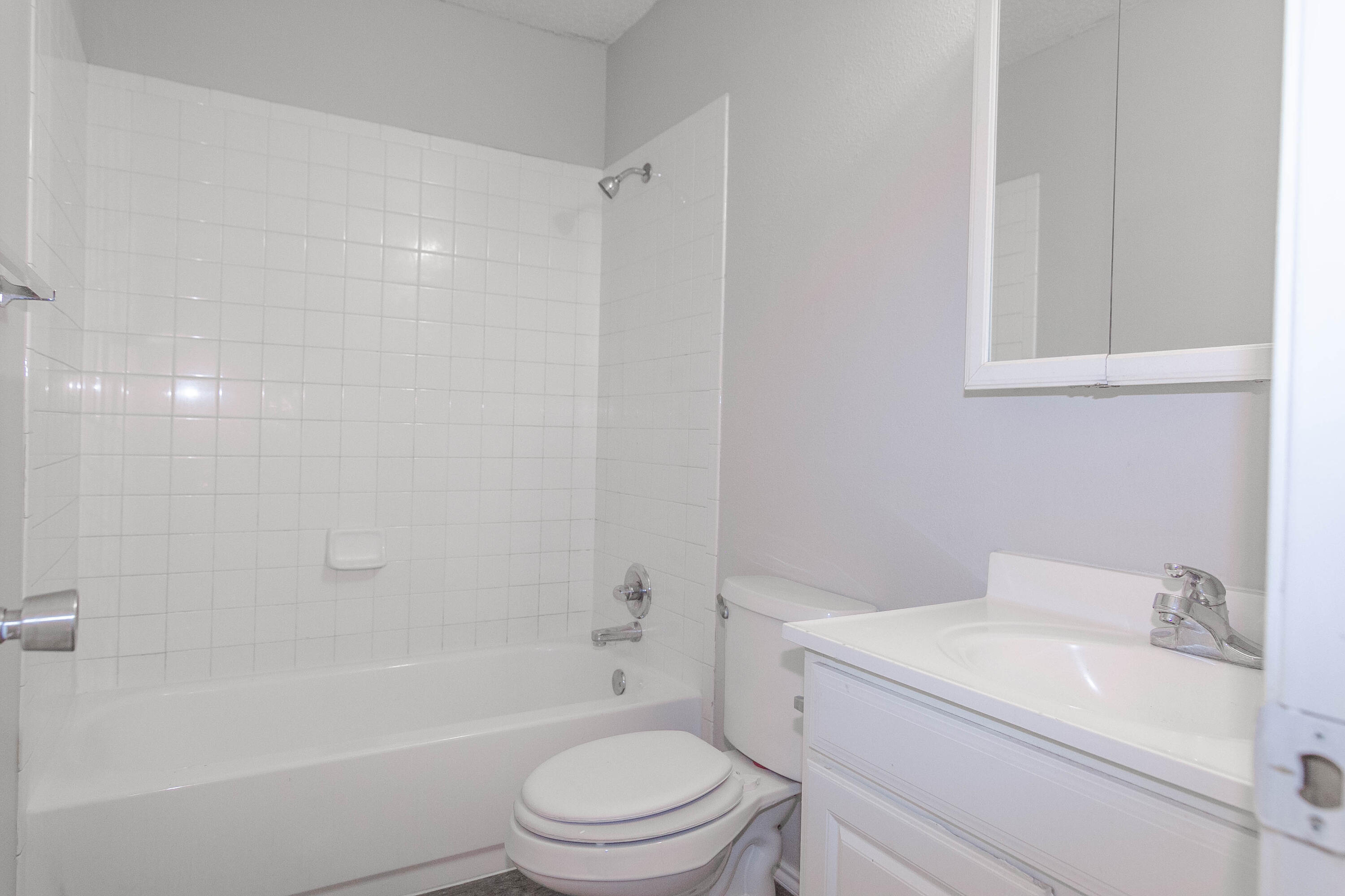 2409 87th Street, Unit B Lubbock, TX 79423 - Photo 6 of 11 a bathroom with a sink toilet and bathtub
