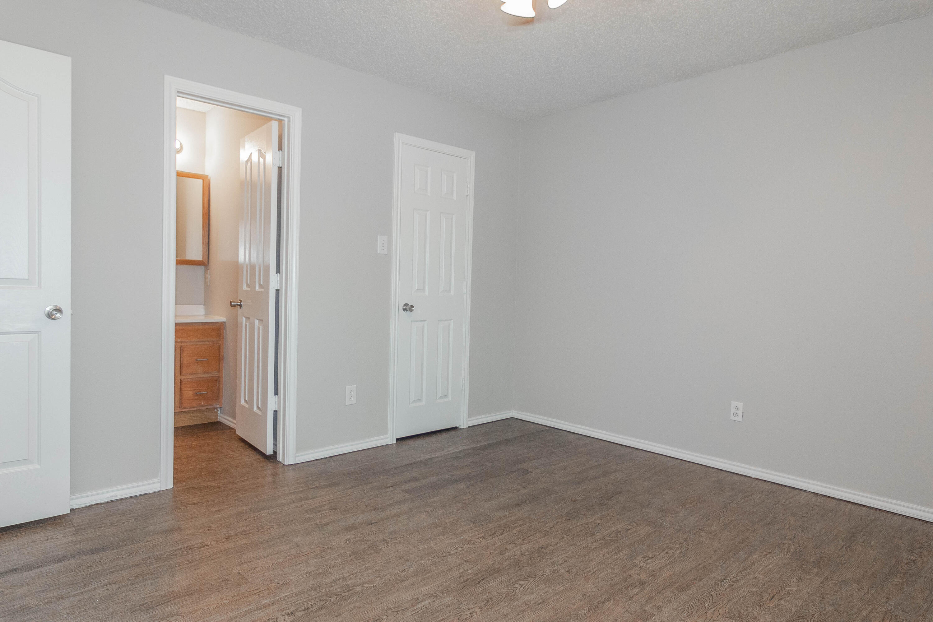 2409 87th Street, Unit B Lubbock, TX 79423 - Photo 7 of 11 wooden floor in an empty room