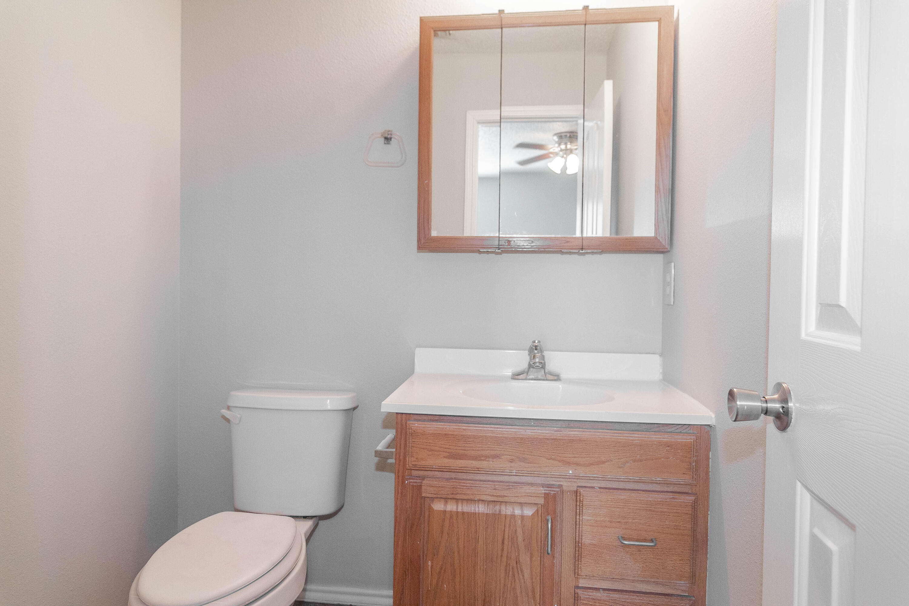 2409 87th Street, Unit B Lubbock, TX 79423 - Photo 9 of 11 a bathroom with a sink vanity mirror and toilet