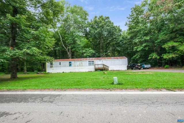 a front view of a house with a yard and a garage