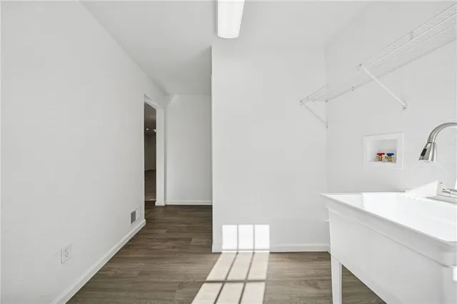 a white toilet sitting next to a bathroom sink