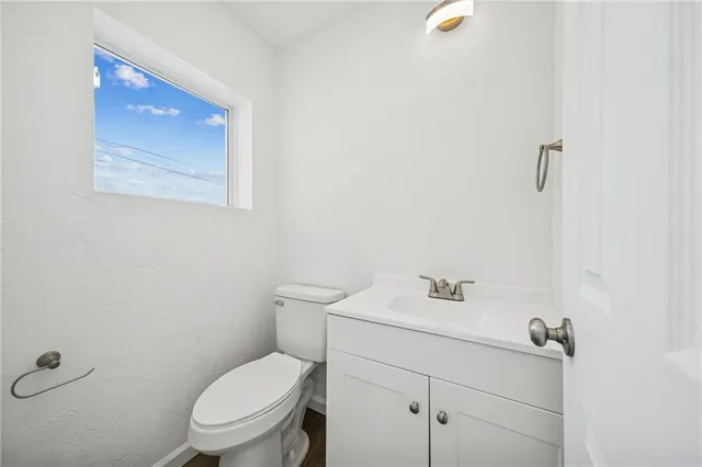 a view of a room with a window and a ceiling fan