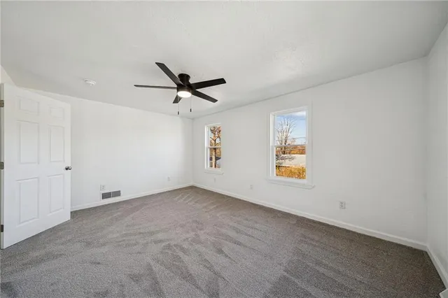 a view of backyard with wooden fence
