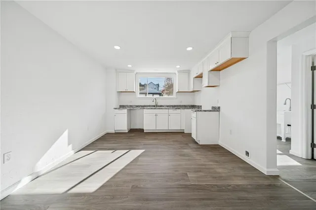 a kitchen with a sink a refrigerator and window