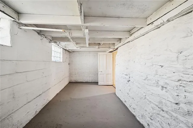 an empty room with a ceiling fan and a window