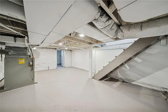 an empty room with a ceiling fan and a window