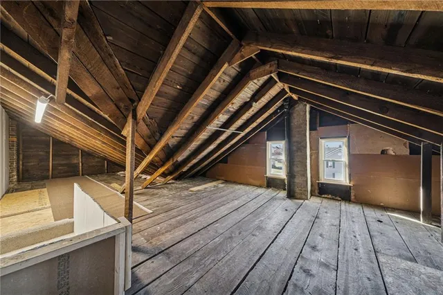 a view of a white house with a yard and sitting area