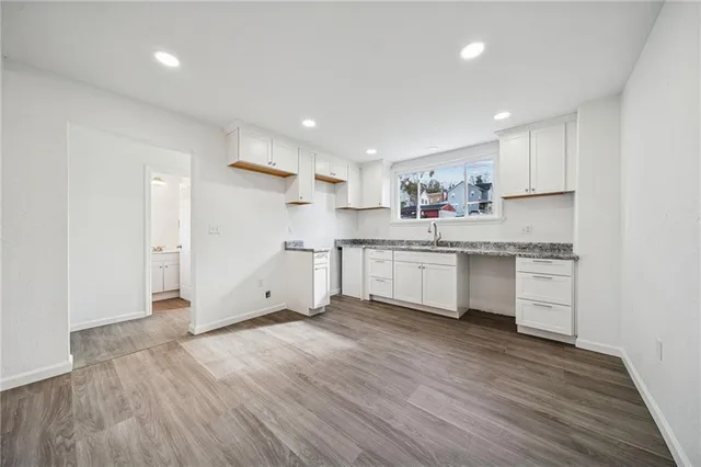 a large white kitchen with a white wooden cabinets and white stainless steel appliances