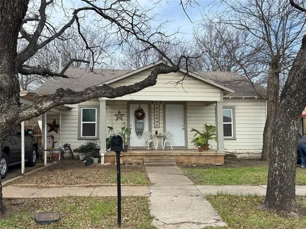 a front view of a house with garden and patio
