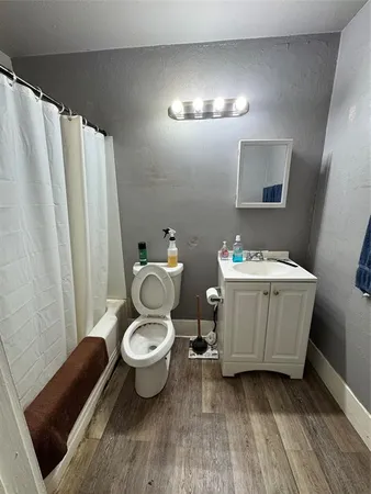 a bathroom with a sink toilet and shower