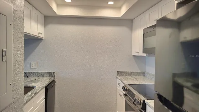 a kitchen with a sink and a stove top oven