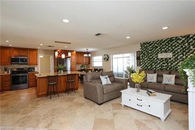 a living room with furniture and kitchen view