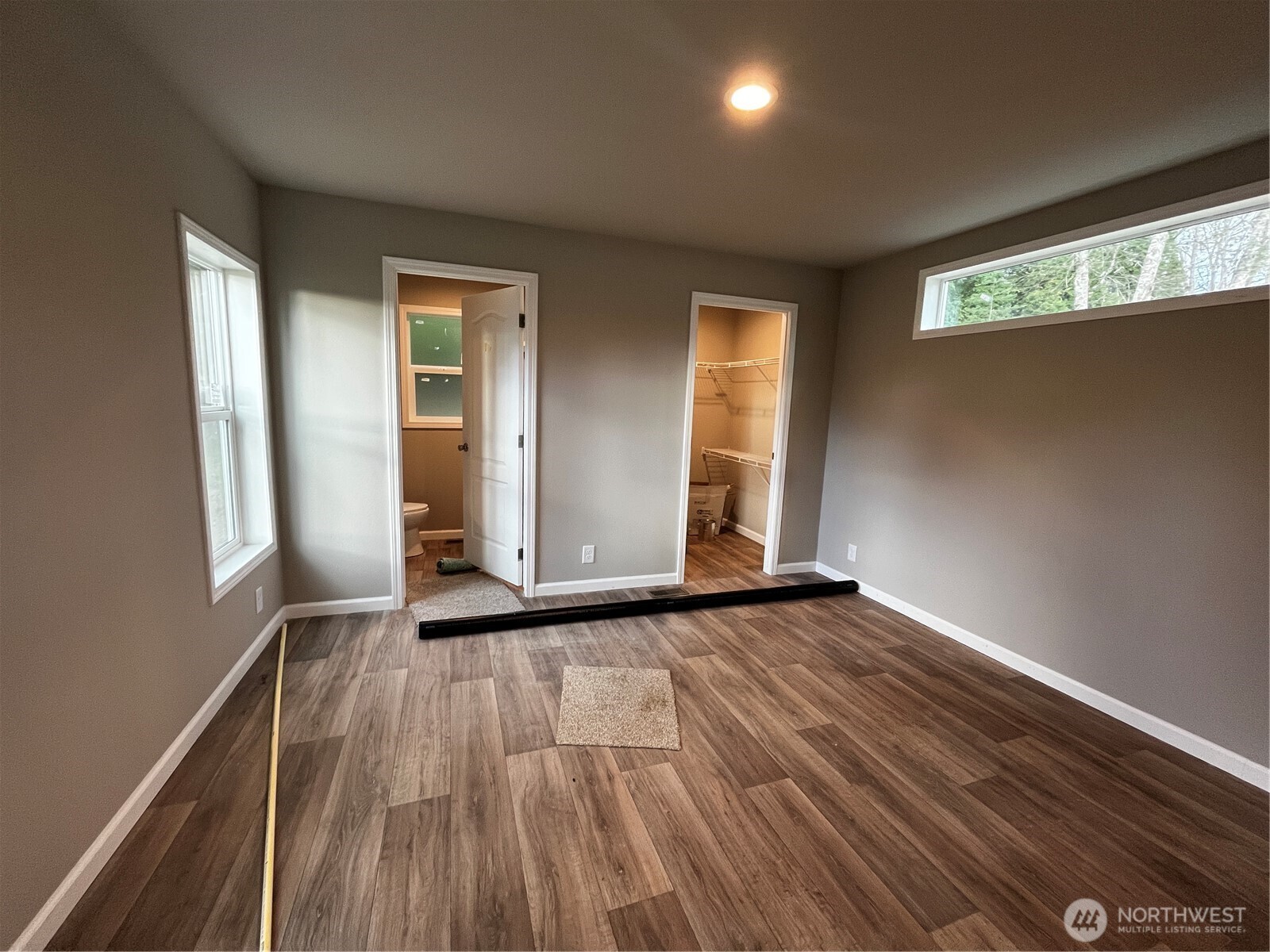 36 Porter Creek Road Elma, WA 98541 - Photo 11 of 16 an empty room with wooden floor and windows