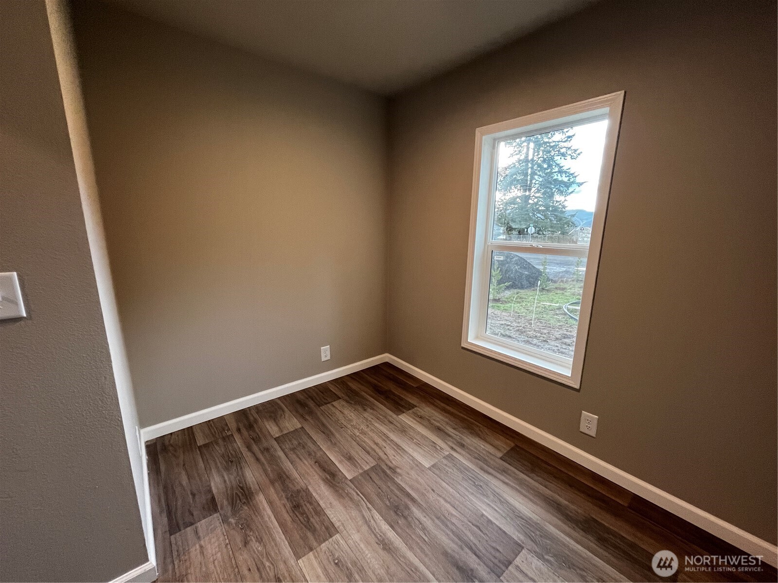 36 Porter Creek Road Elma, WA 98541 - Photo 12 of 16 an empty room with wooden floor and windows