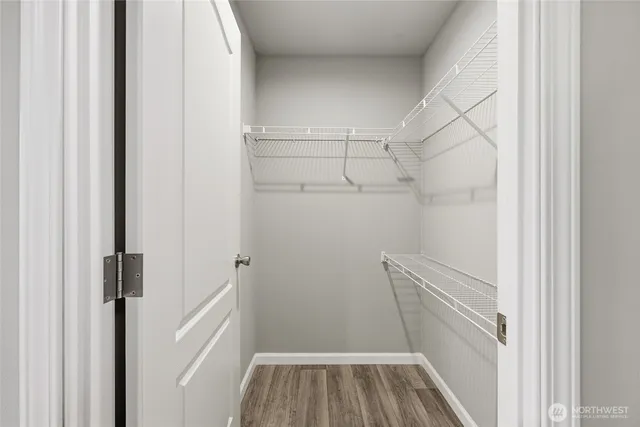 a view of walk in closet with empty racks
