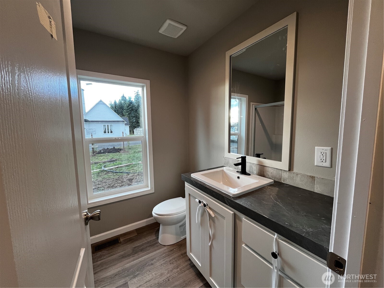 36 Porter Creek Road Elma, WA 98541 - Photo 13 of 16 a bathroom with a granite countertop sink a toilet a mirror and window