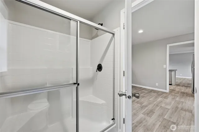a bathroom with a glass door shower