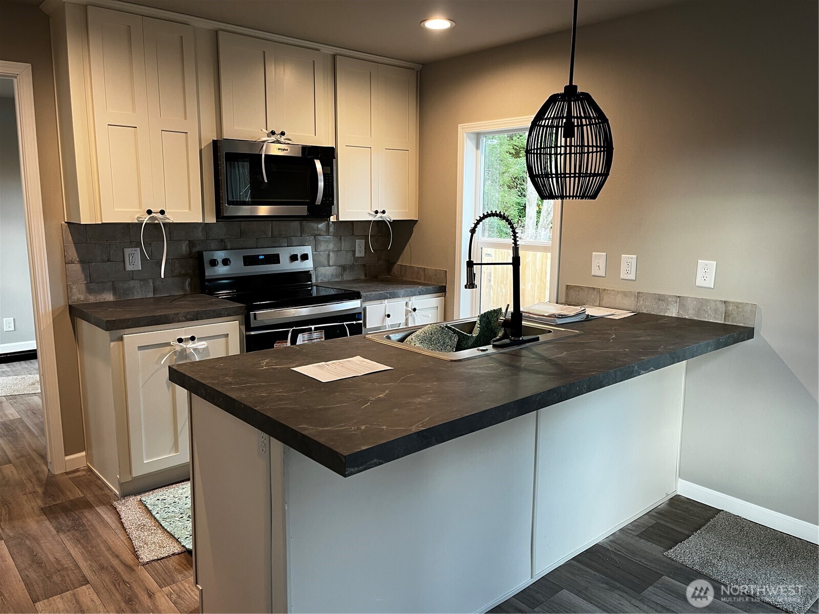 36 Porter Creek Road Elma, WA 98541 - Photo 8 of 16 a kitchen with stainless steel appliances granite countertop a sink a stove and a microwave
