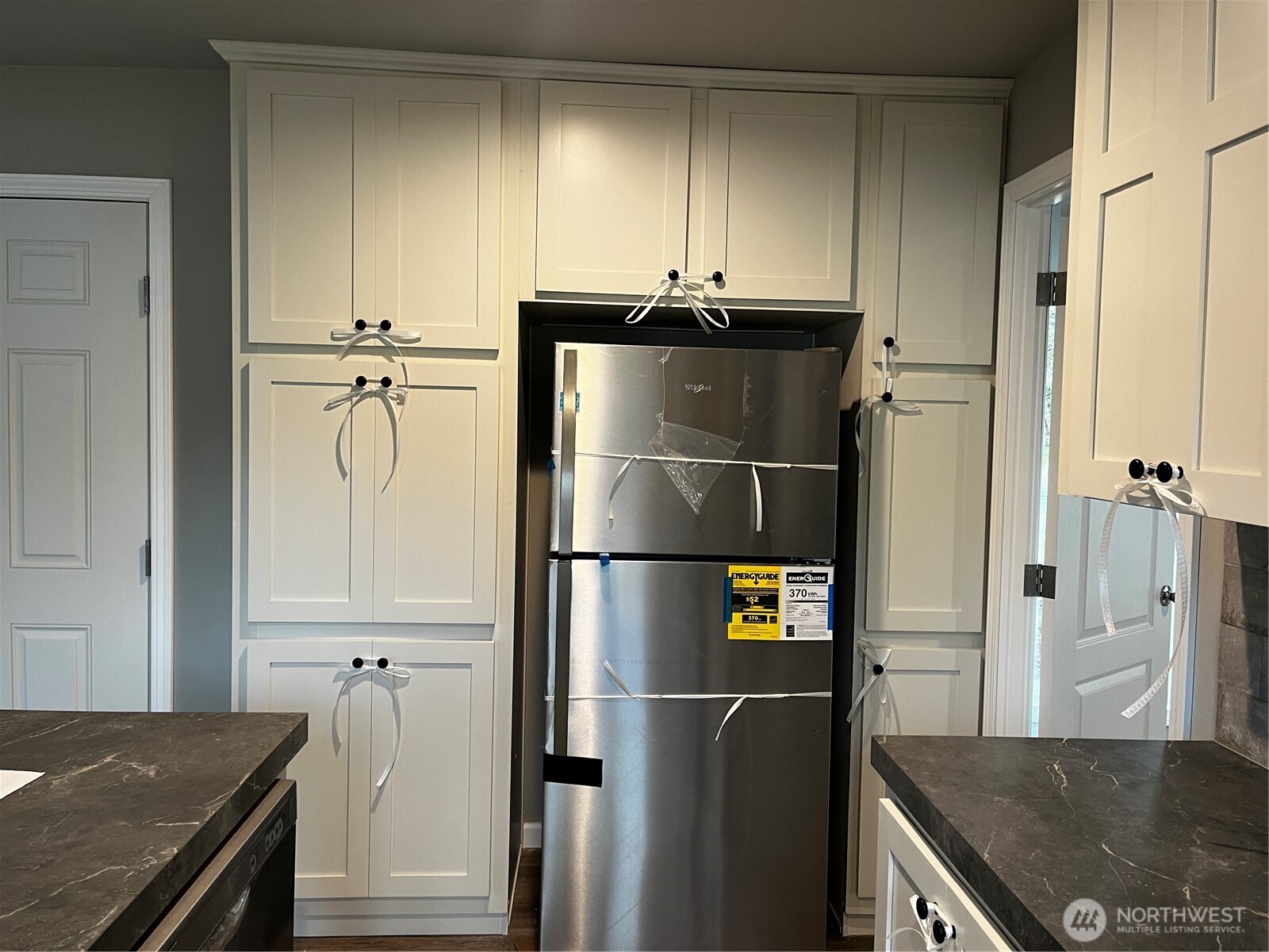 36 Porter Creek Road Elma, WA 98541 - Photo 9 of 16 a kitchen with stainless steel appliances granite countertop a refrigerator a stove and a sink with wooden floor