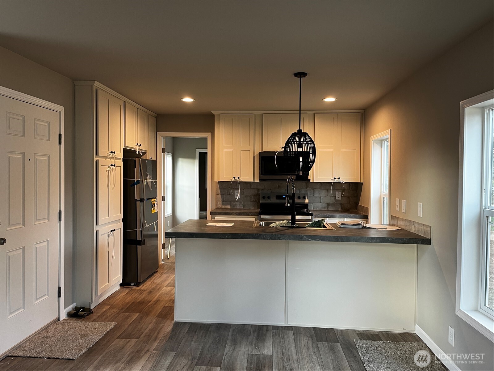 36 Porter Creek Road Elma, WA 98541 - Photo 10 of 16 a kitchen with kitchen island granite countertop a sink cabinets and stainless steel appliances