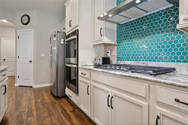 a kitchen with a sink stainless steel appliances and cabinets